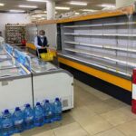 A shopper walks past an empty shelf at a supermarket in Hammana, Lebanon, August 22. Photo: Mohamed Azakir/Reuters