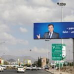 A poster of Lebanese Information Minister George Kordahi is seen on a billboard in Sanaa, Yemen Oct. 31. The billboard reads: "Yes George, Yemen's war is futile." Photo: Khaled Abdullah/Reuters